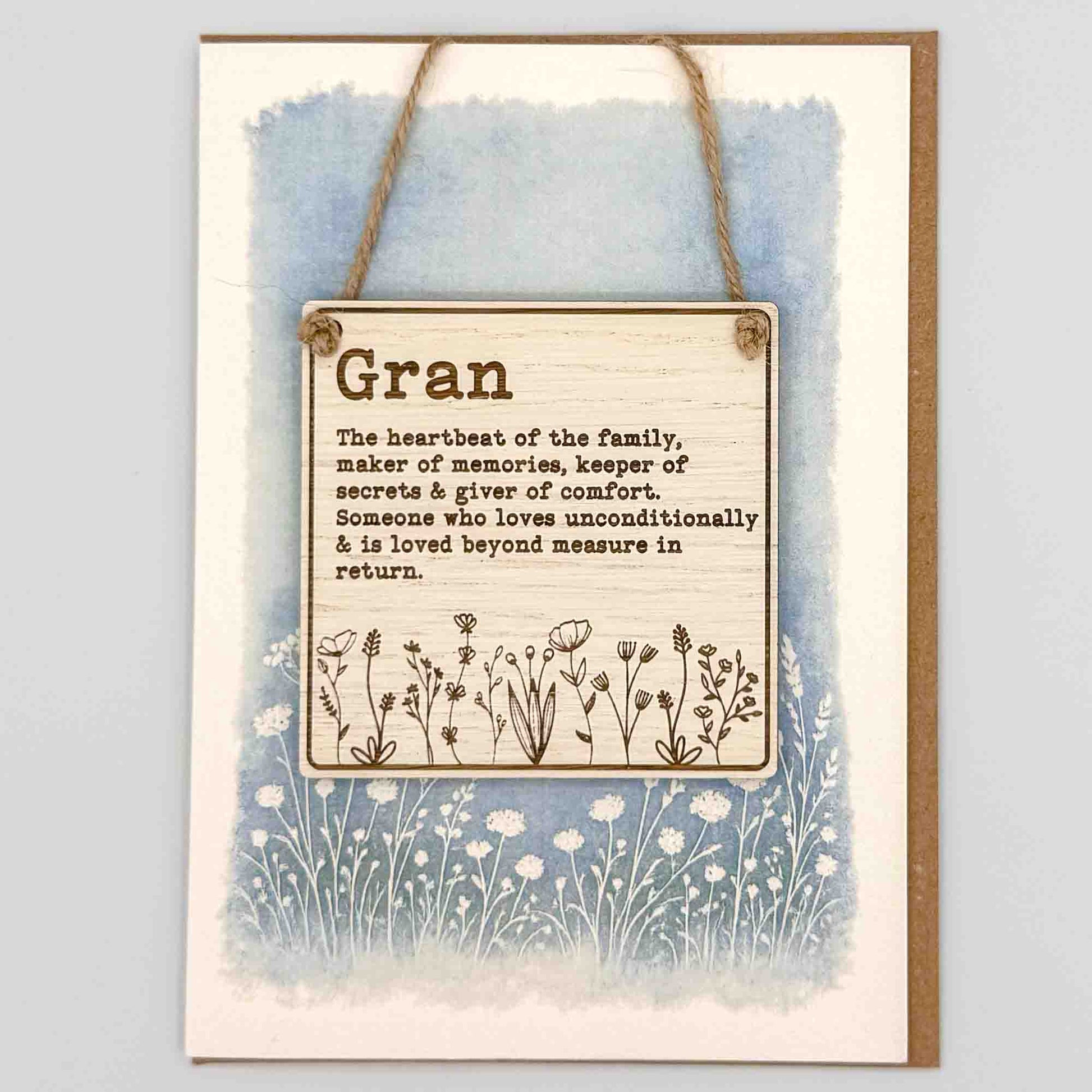 Decorative sign with text and floral design on a watercolor background